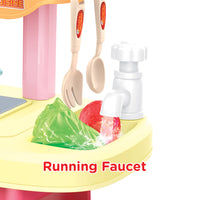 Toy kitchen set with running faucet and utensils on a white background