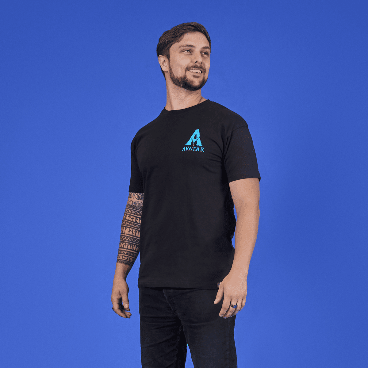Man wearing a black t-shirt with a blue logo on a blue background