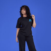 Person wearing a black t-shirt with a logo on a blue background