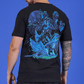 Person wearing a black t-shirt with a blue and green alien design on the back against a blue background