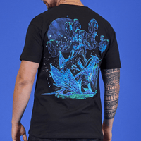Person wearing a black t-shirt with a blue and green alien design on the back against a blue background
