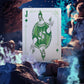 Playing card with a green joker design in a fantasy setting with rocks and glowing blue energy.