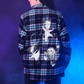 Person wearing a plaid shirt with graphic designs on the back against a blue gradient background