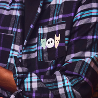 Plaid shirt with cartoon character design on a pocket