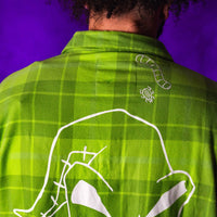 Green plaid shirt with white line art on a purple background