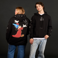Two people wearing black hoodies with cartoon character designs on a dark background