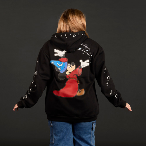 Person wearing a black hoodie with a cartoon character on the back against a dark background