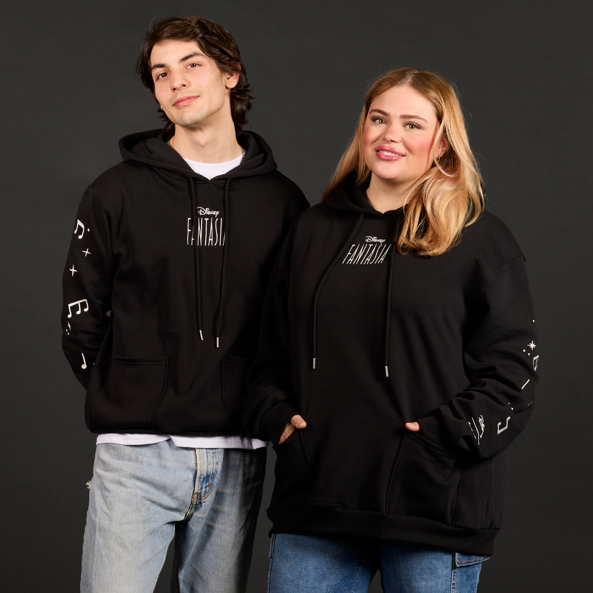Two people wearing black hoodies with 'Fantasia' text on a dark background