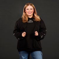 Woman wearing a black hoodie with 'Fantasia' text on a dark background