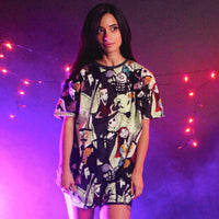 Woman wearing a colorful dress with graphic design against a purple background with string lights.