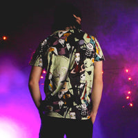 Person wearing a colorful patterned shirt with a dark background