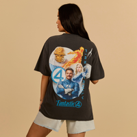 Person wearing a black t-shirt with 'Fantastic 4' graphic design on a beige background