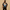 Person wearing a black t-shirt with 'Fantastic 4' graphic design on the back against a beige background