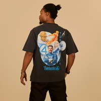 Person wearing a black t-shirt with 'Fantastic 4' graphic design on the back against a beige background