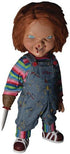 Toy figure of a character with red hair, striped shirt, and overalls holding a knife.