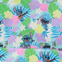 Fabric with cartoon character surrounded by flowers and leaves on a colorful background