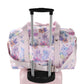 Pink duffel bag with cartoon character and floral pattern on a white background