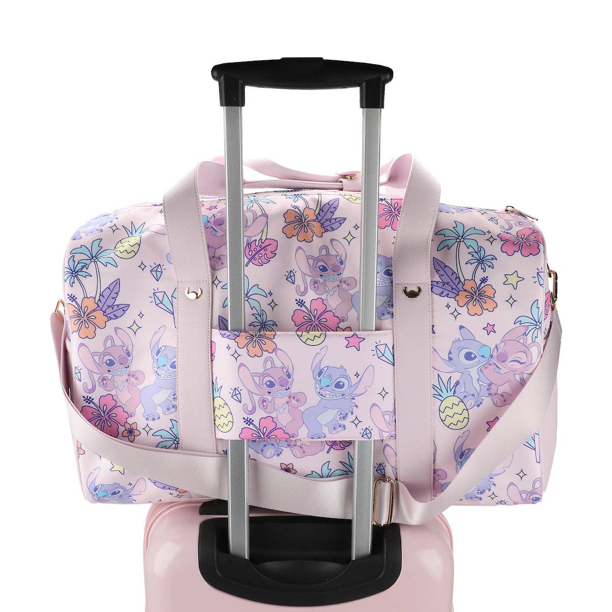 Pink duffel bag with cartoon character and floral pattern on a white background