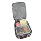 Open lunch bag with compartments containing a sandwich, apple, and snacks on a white background