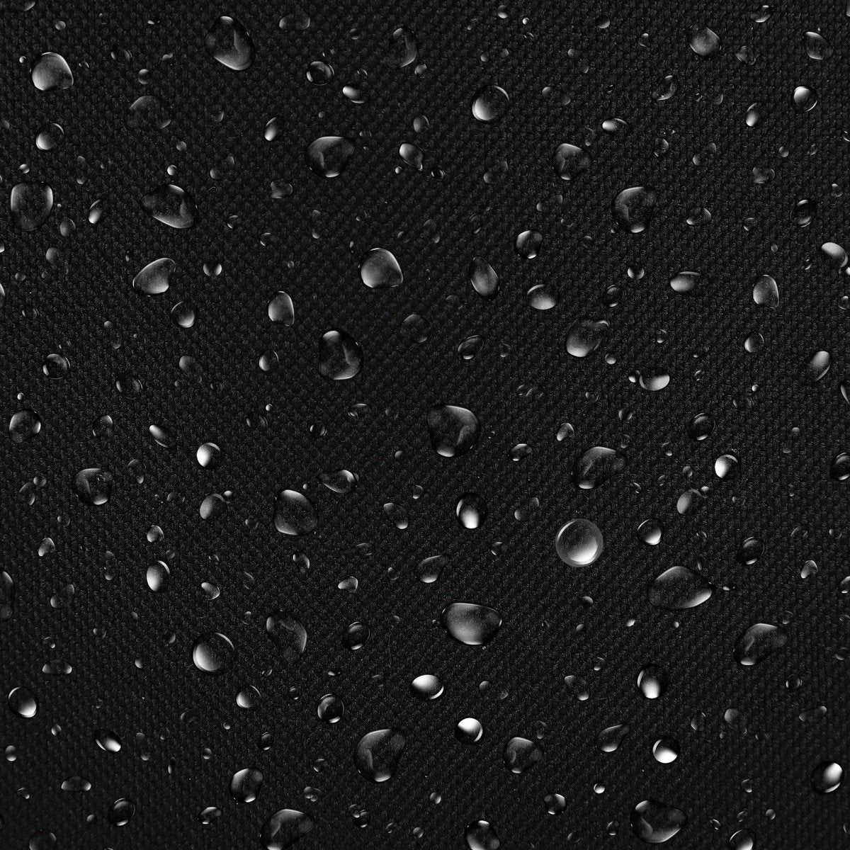 Water droplets on a black textured surface