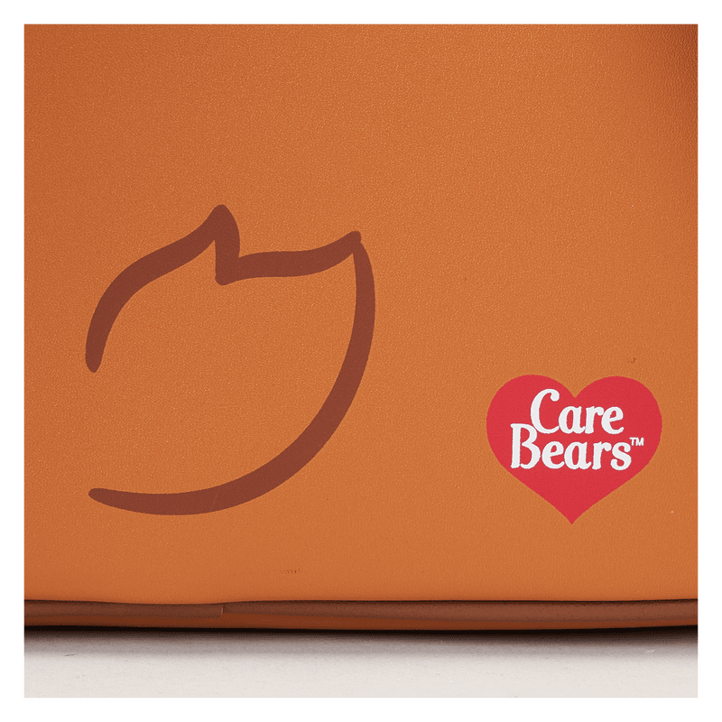 Close-up of Tenderheart Bear plush mini backpack showing embroidered heart and soft plush texture