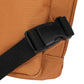 Close-up of a brown bag with a black strap and buckle on a white background