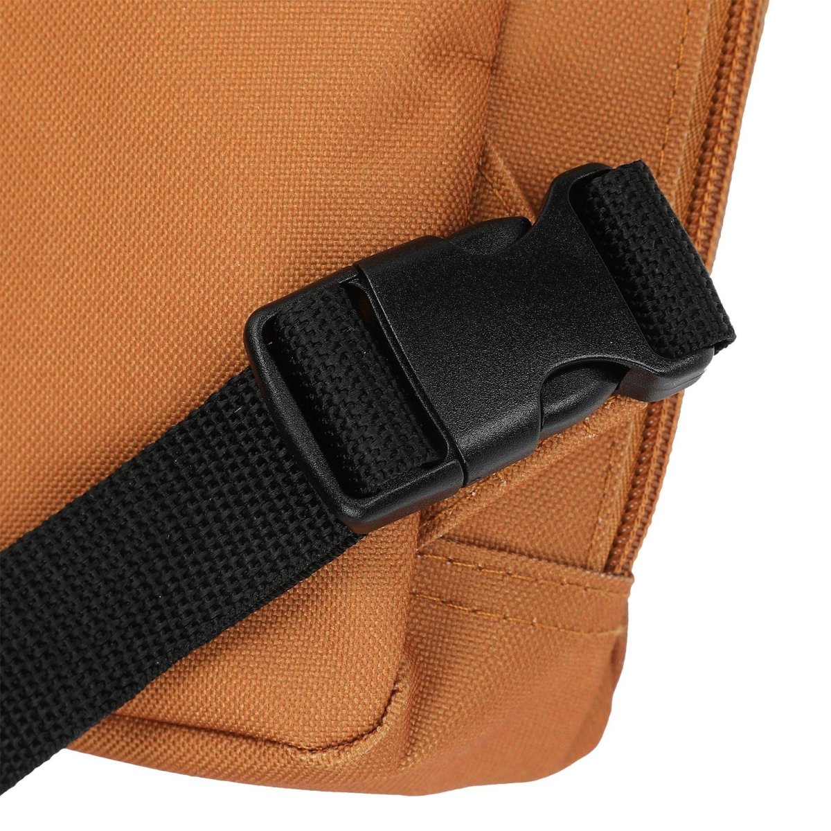 Close-up of a brown bag with a black strap and buckle on a white background