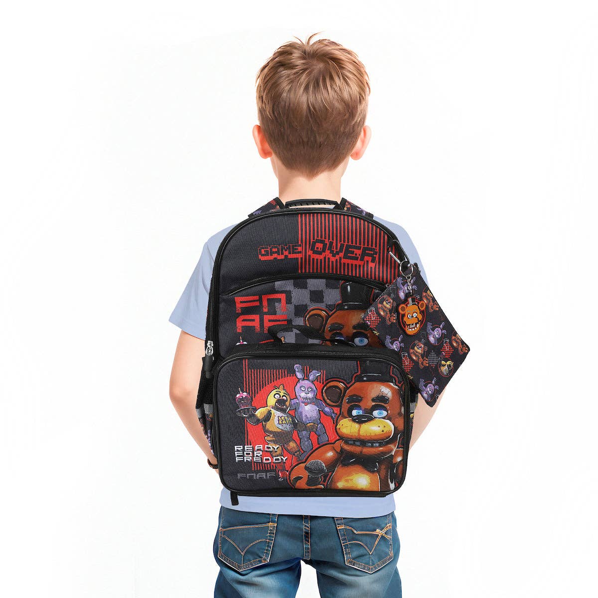Child wearing a Five Nights at Freddy's themed backpack on a white background