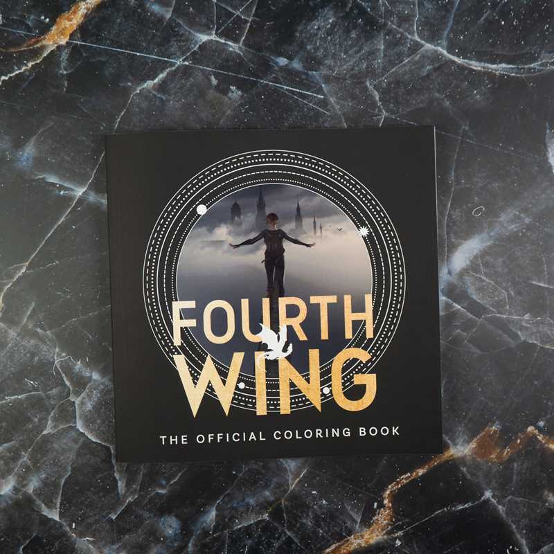 Fourth Wing coloring book on a marble surface