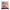 Framed collectible figure of a doll in a pink dress with 'Dolly' branding.