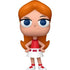 Toy figure of a character with red hair, blue eyes, and a red dress on a white background