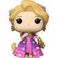 A Funko Pop! vinyl figure of Rapunzel from Tangled, featuring her signature blonde hair, purple and pink dress with gold star accents, and gold accessories, set against a plain white background.
