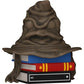 Decorative item resembling a Sorting Hat from a fantasy book with books underneath on a white background