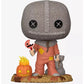 Funko Pop! vinyl figure of the character Leatherface from The Texas Chain Saw Massacre, featuring his signature gray knit mask, orange tattered suit, and accessories including a jack-o'-lantern and a cellophory bag, set against a plain white background.