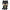 Batman figurine with black cape and yellow belt on a white background