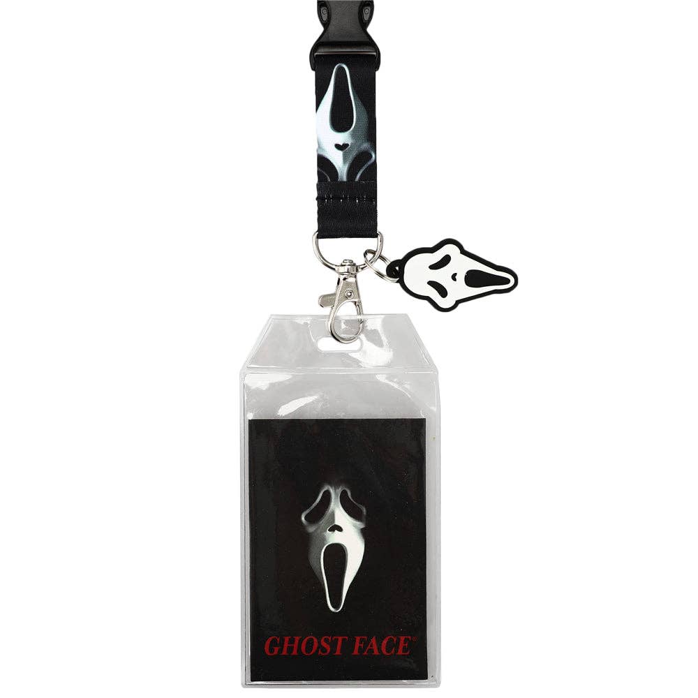 A Ghost Face themed lanyard and ID badge holder set, featuring a black strap with a white Ghost Face mask print, a silver clasp, a clear plastic badge sleeve, and a small black-and-white Ghost Face charm. The sleeve is printed with a large Ghost Face mask and the text 'GHOST FACE' in red at the bottom.