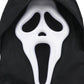 Halloween mask with a white face and black eyes and mouth on a black background