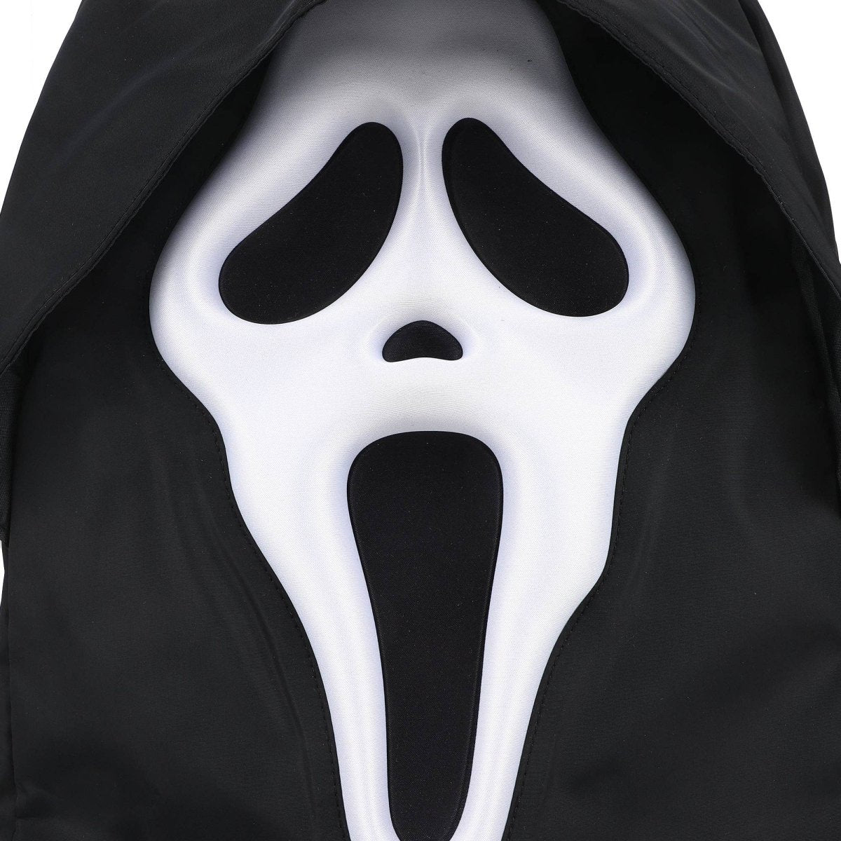 Halloween mask with a white face and black eyes and mouth on a black background