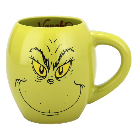 Green mug with a face design on a white background