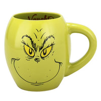 Green mug with a face design on a white background