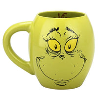 Green mug with a face design on a white background