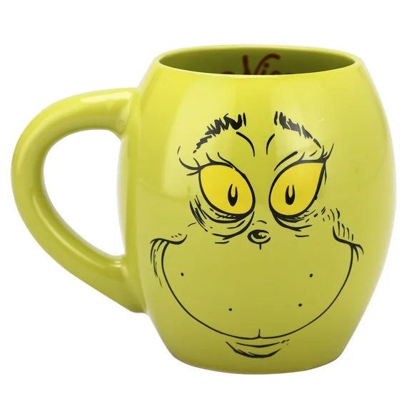 Green mug with a face design on a white background