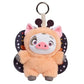 A plush pig character keychain or bag charm with pink ears, a white face, a pink snout, and dark patterned wings on a plain white background.