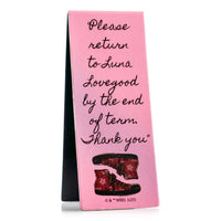 Pink book with black text and red shoes illustration on a white background