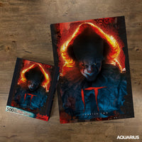 Two 'It' themed puzzles on a wooden surface, featuring a character with red hair and a red 'T'.