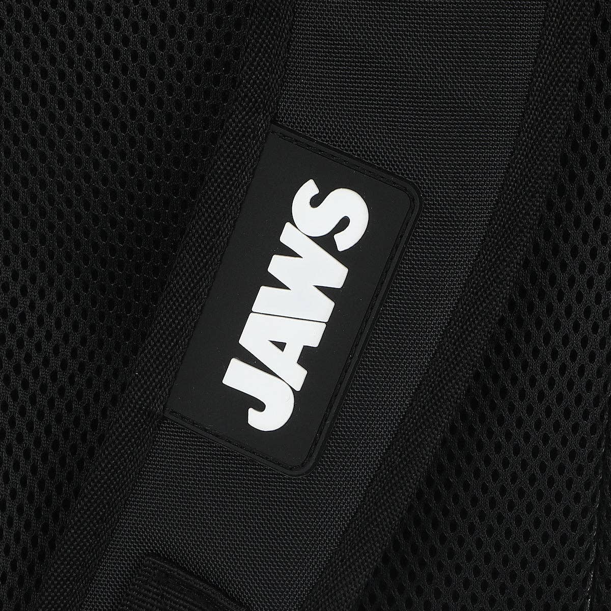 Black backpack with 'JAWS' logo on a black background