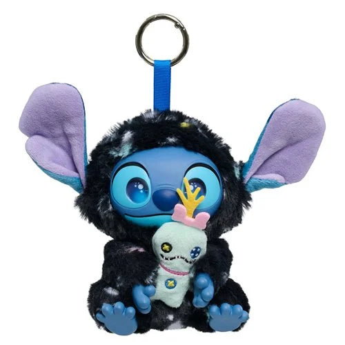 A Stitch plush keychain holding a small white plush toy, set against a plain white background. The Stitch figure has large blue eyes, purple ears, and a black fuzzy body, attached to a blue strap and silver key ring.
