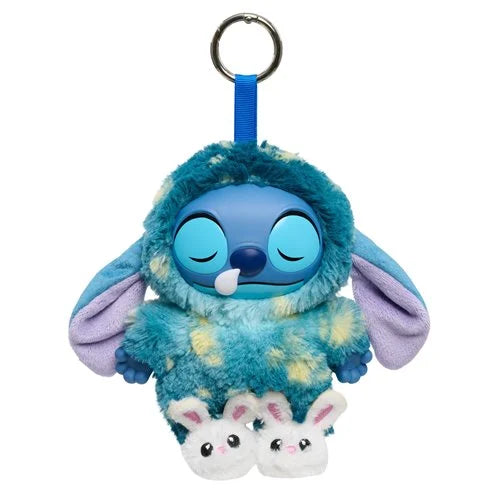 Plush keychain with a blue character and two small white creatures on a white background