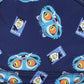 A close-up of a navy blue fabric featuring a repeating pattern of cartoon blue tiger faces with large orange eyes and small rectangular character prints.