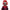 Colorful clown mask with red hair and a striped outfit on a white background